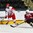 GRAND FORKS, NORTH DAKOTA - APRIL 24: Denmark's Oliver Larsen #5 plays the puck while Latvia's Vladislavs Nazarovs #25 defends during relegation round action at the 2016 IIHF Ice Hockey U18 World Championship. (Photo by Matt Zambonin/HHOF-IIHF Images)


